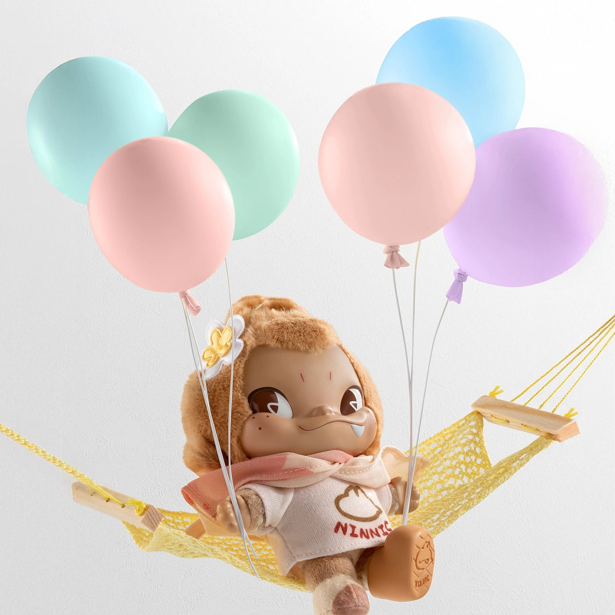 Secret Sunny Getaway NINNIC relaxing in a yellow hammock with balloons, NINNIC Wild & Free