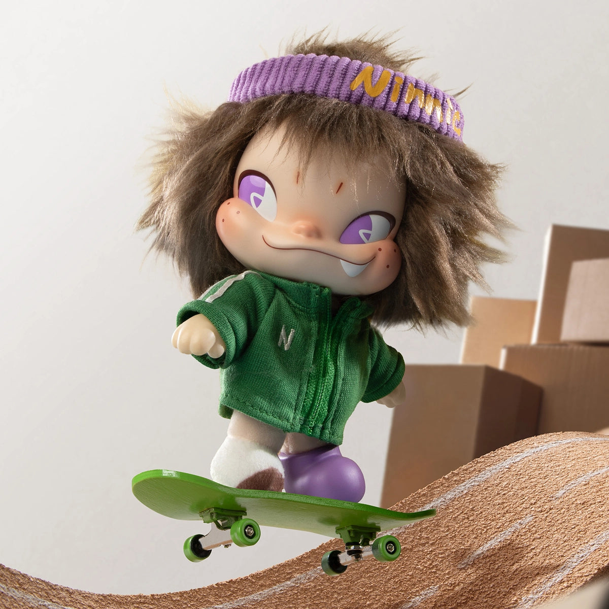 Frizzy Fella NINNIC in green track jacket and NINNIC headband on a skateboard, NINNIC Wild & Free