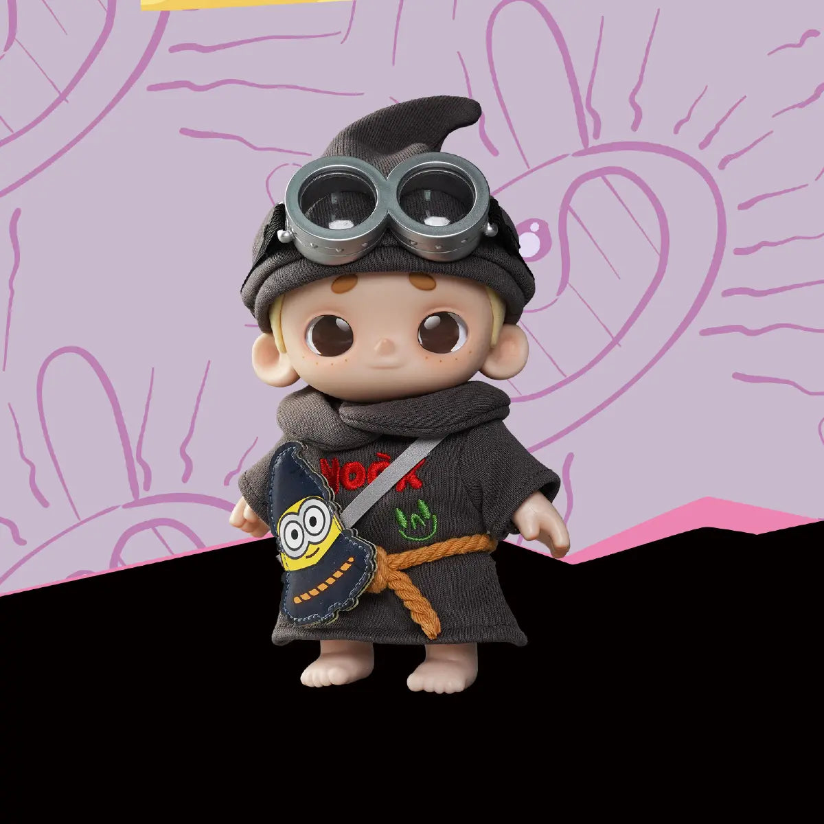 NOOK Wizard Minion Ed plush figure posed against a purple Minions graphic
