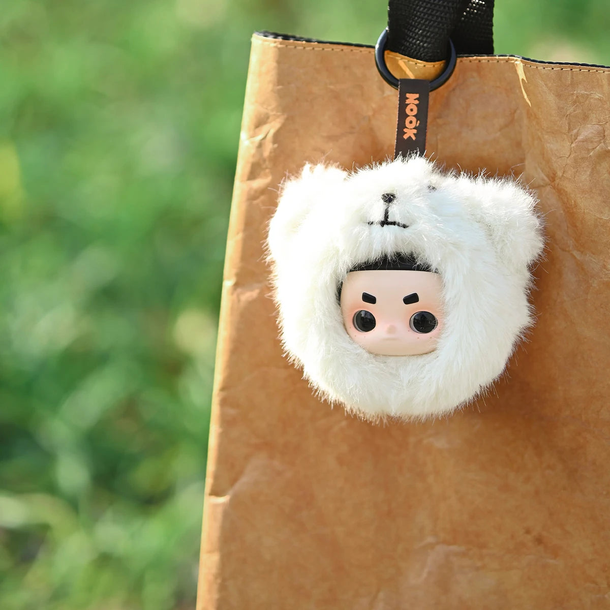 Polar Brave Nook polar-bear hood charm clipped to a kraft tote bag outdoors, My Date with the Forest
