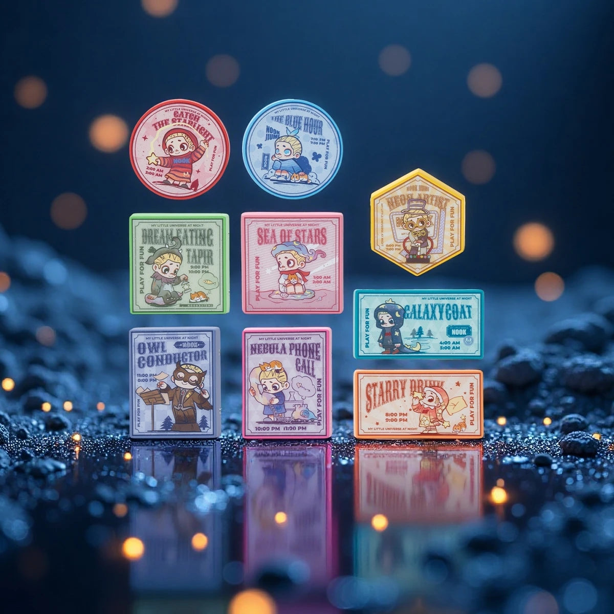 Full set of nine NOOK Night Series light-up badge fridge magnets glowing on dark stones