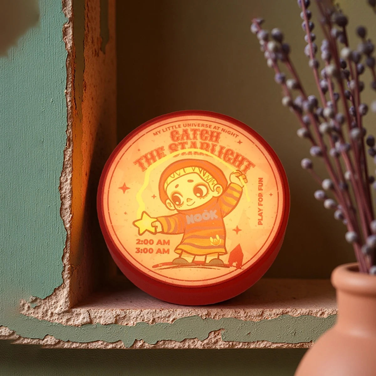 Catch the Starlight round magnet glowing on a shelf, NOOK Night Series