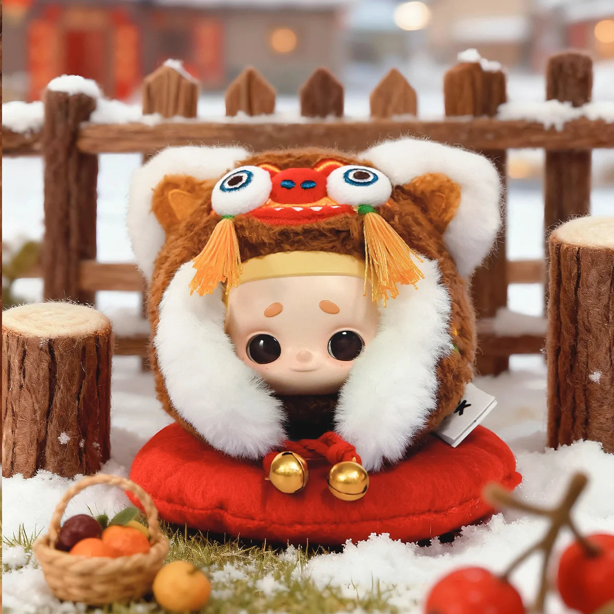Brown Tiger-Head Hat Nook charm on a red cushion by a snowy fence with fruit basket