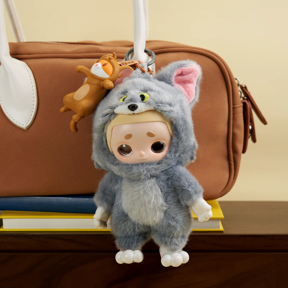 Nook Tom cat plush with a Jerry mouse charm clipped to a brown bag, Nook x Tom and Jerry