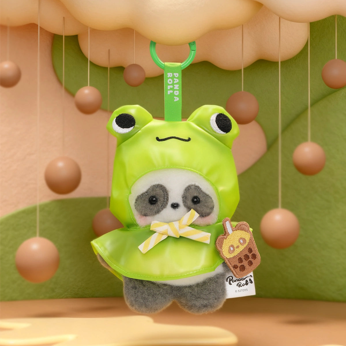 Panda Ribbit plush charm in green frog raincoat holding a boba tea among raindrops, Panda Roll Happy Weekend