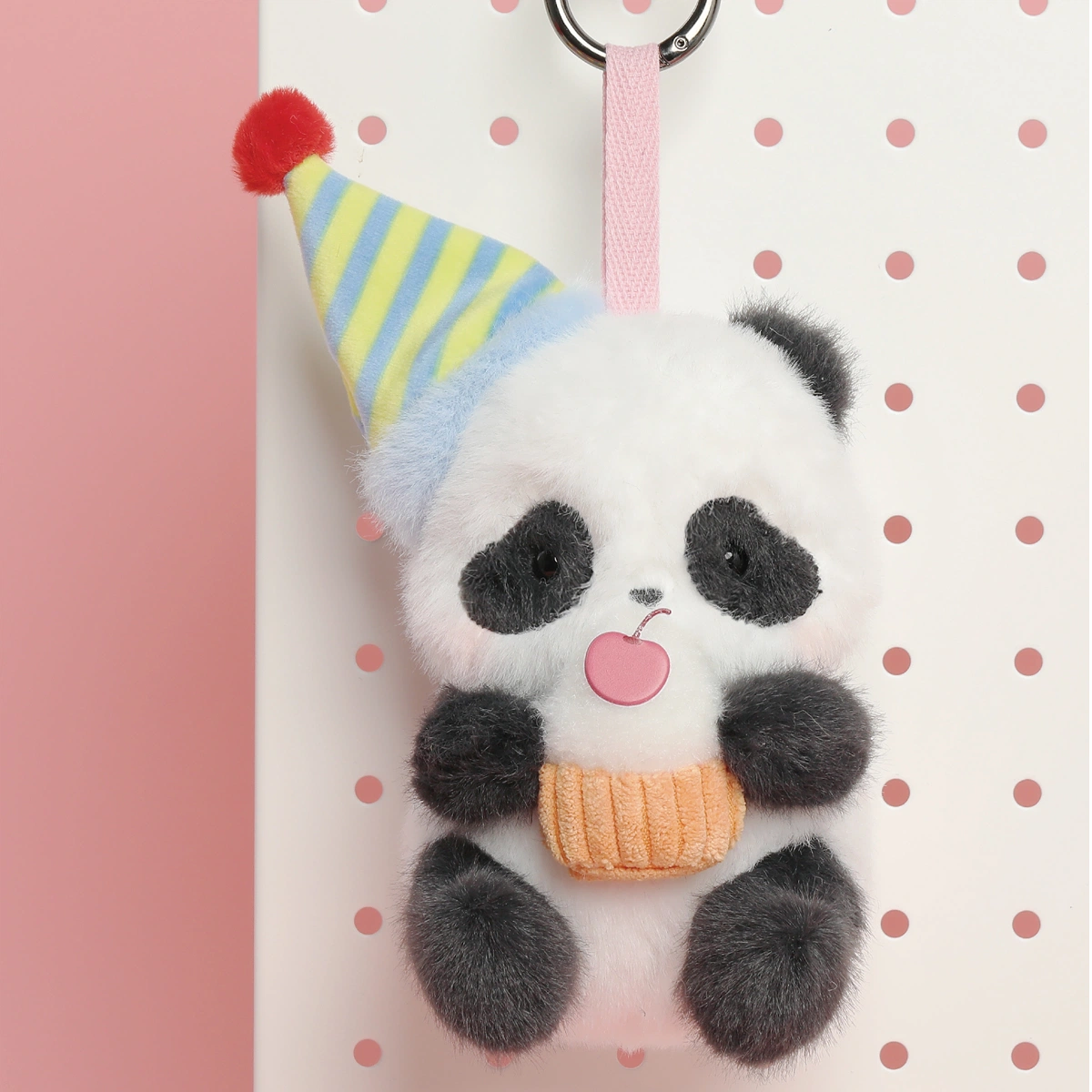 Full set of party-hat Panda Roll plush keychains with cookie, cupcake and banners beside the blind box by 52TOYS