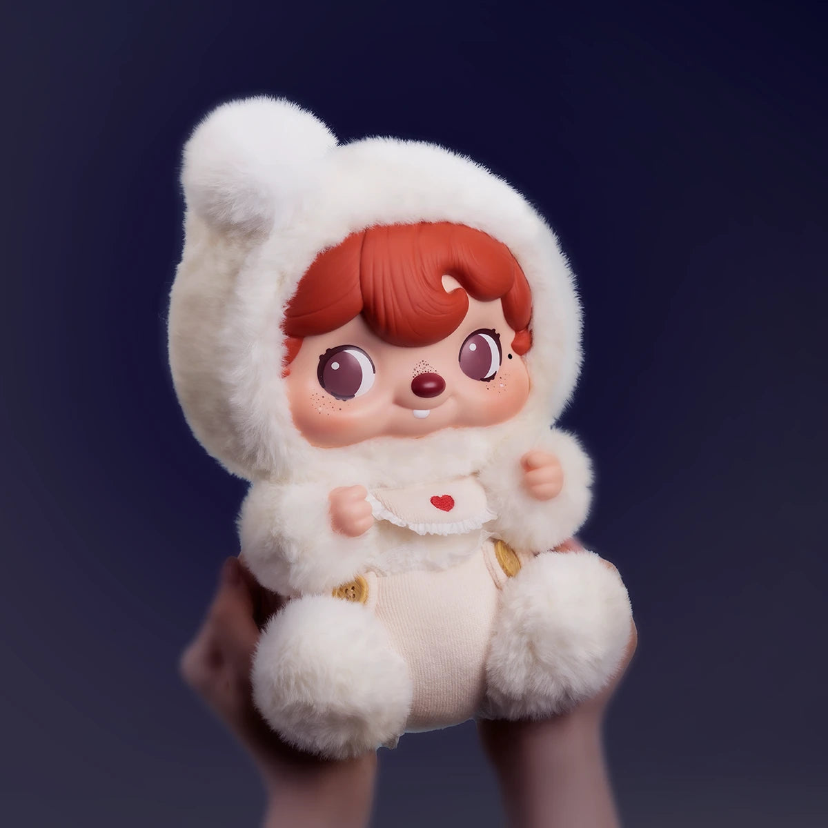 POUKAPOUKA Cloud Baby plush cradled in hands on a deep blue backdrop, baby POUKA in fluffy white bunting