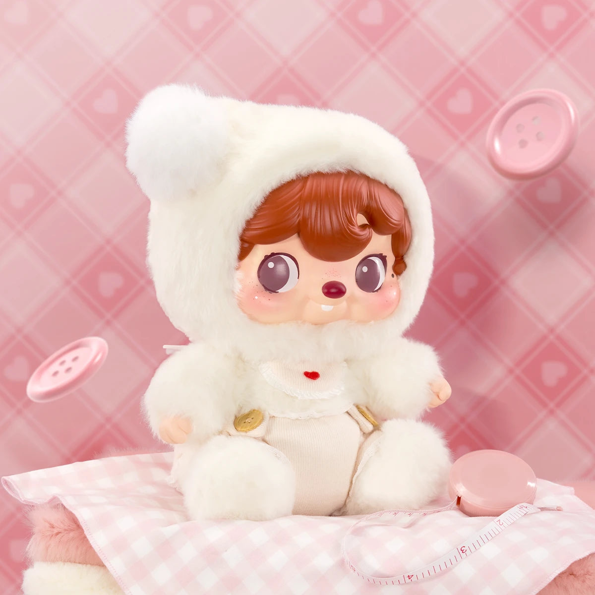 POUKAPOUKA Cloud Baby plush on a pink gingham scene with buttons, baby POUKA in white bear-eared hood