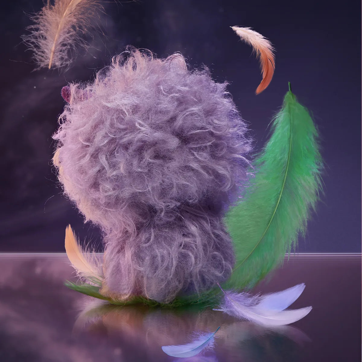 Back of Fuzz-Mad Beast purple shaggy plush among colorful feathers, POUKAPOUKA Me & I secret