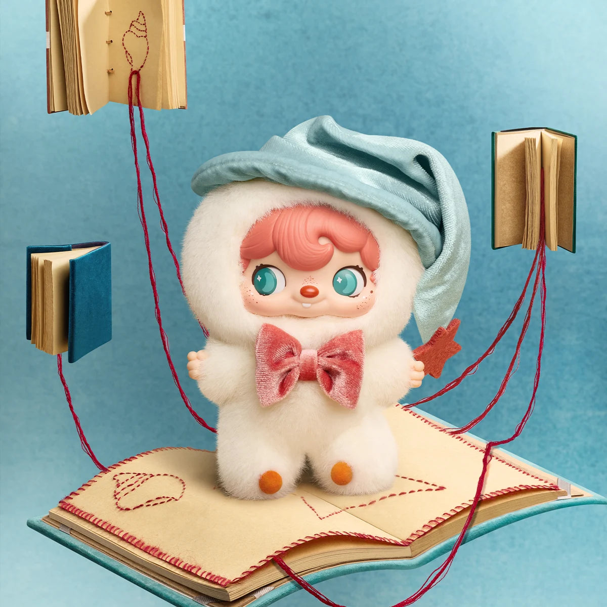 Mystic Conch plush with blue shell hood and pink bow on floating books, POUKAPOUKA Me & I