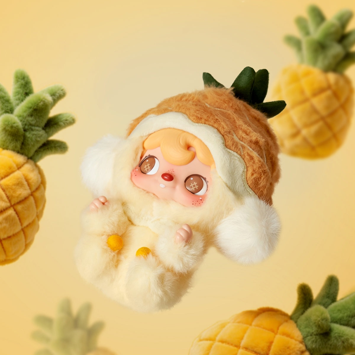 POUKAPOUKA Mini Pineapple vinyl plush posed among hanging pineapple decorations
