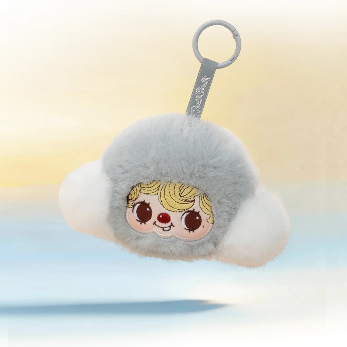 POUKAPOUKA Pocket Cosmos earphone case floating over a pastel sky, grey cloud plush keychain with keyring