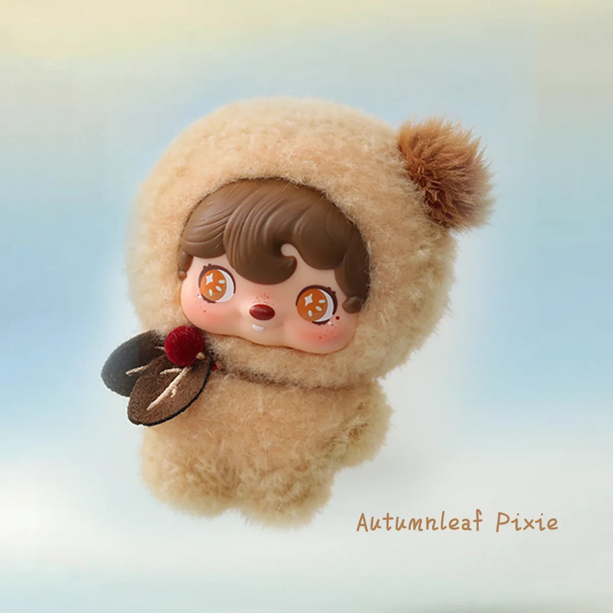Autumnleaf Pixie in a tan pom-pom hood with leaf and berry accents, POUKAPOUKA Pocket Cosmos by 52TOYS