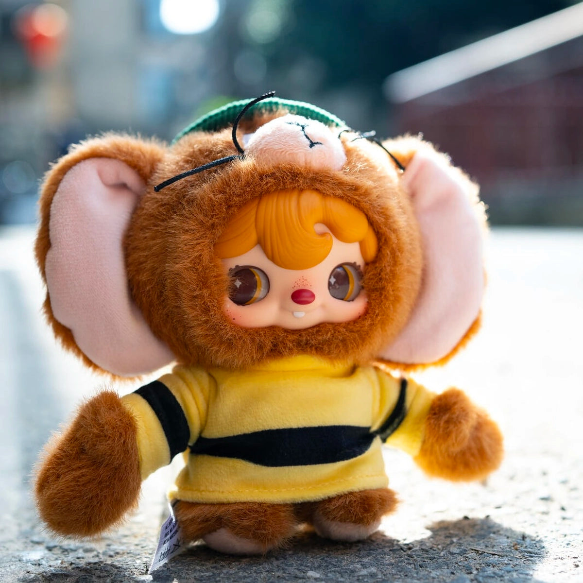 Secret POUKAPOUKA in a Jerry costume and green cap outdoors