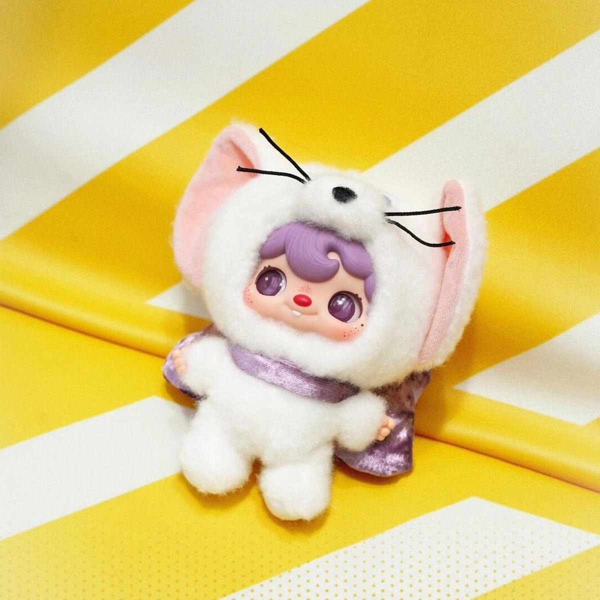 POUKAPOUKA white Tom costume plush posed on a yellow striped seat
