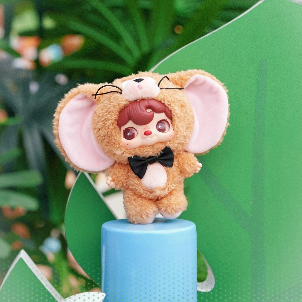 POUKAPOUKA brown Jerry costume plush standing on a blue pedestal