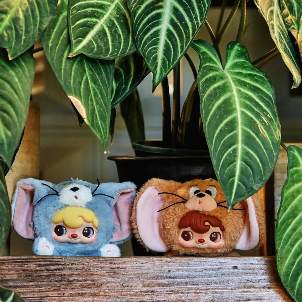 POUKAPOUKA gray Tom and brown Jerry costume plush toys peeking through houseplants
