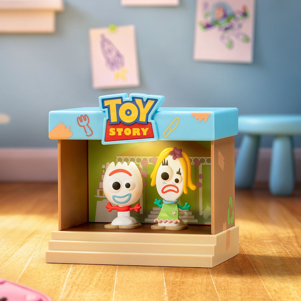 Forky and Karen Beverly standing together inside a craft-room stage frame