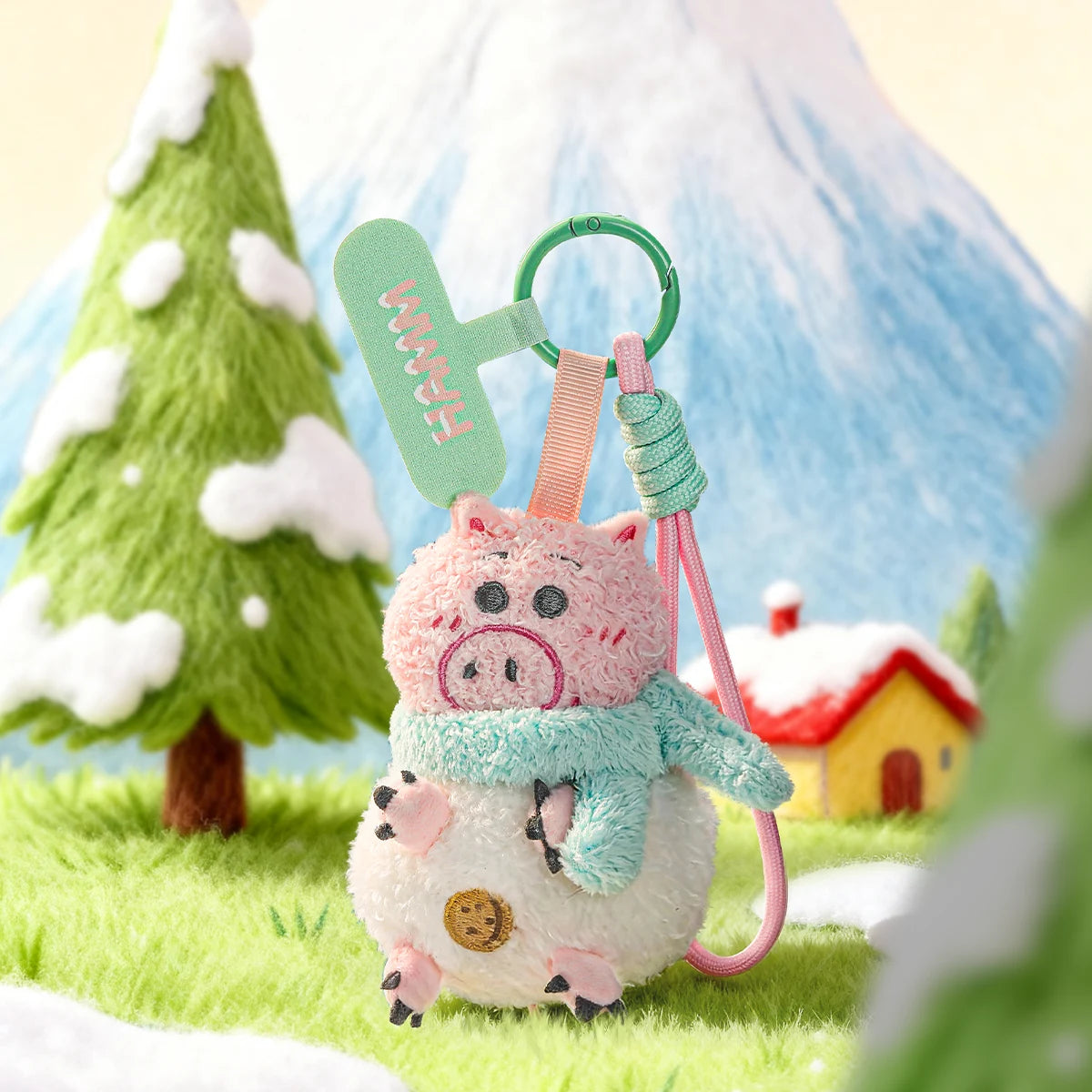 Hamm plush phone charm in a white snowball costume with mint scarf