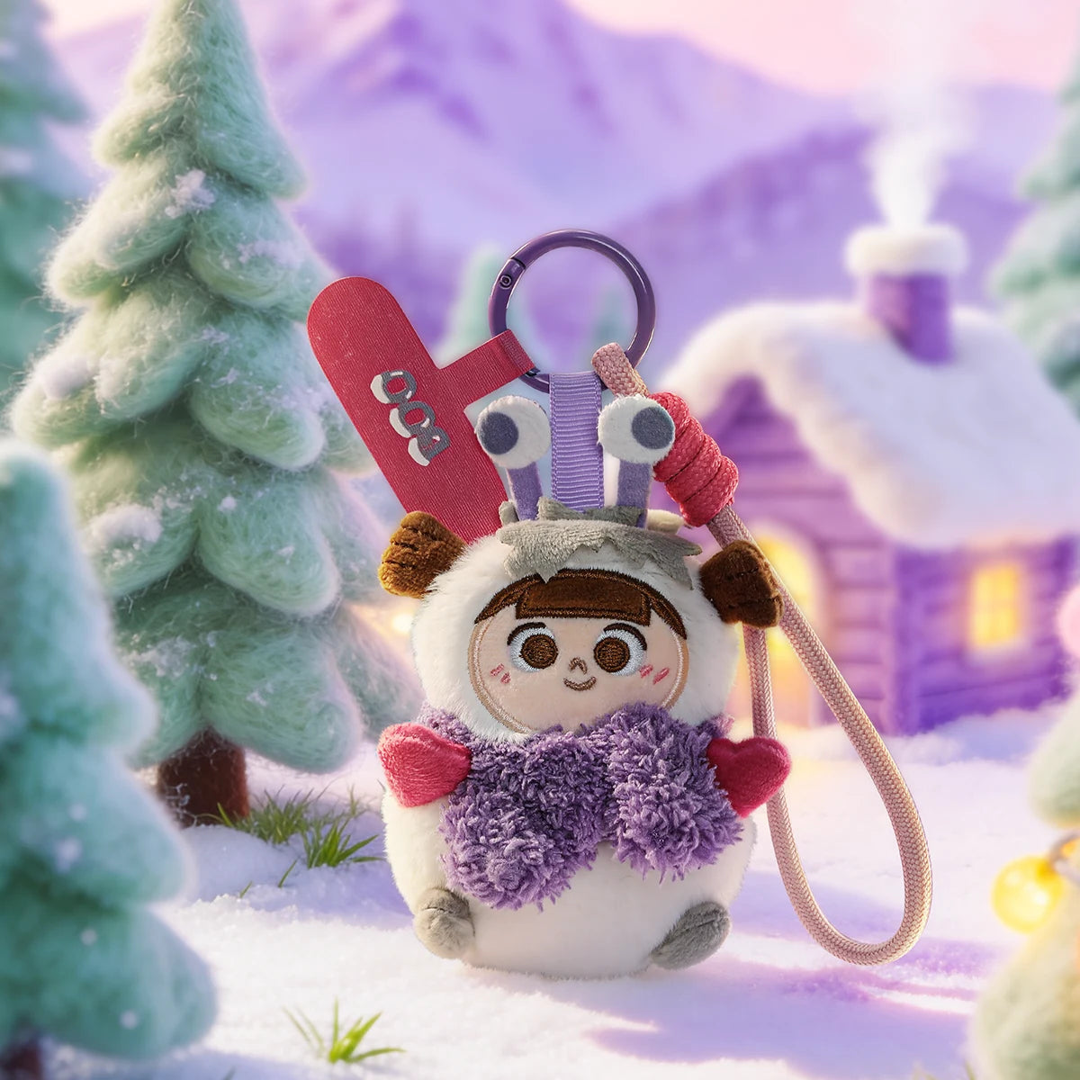 Boo plush phone charm in a white snowball costume with purple scarf and earmuffs